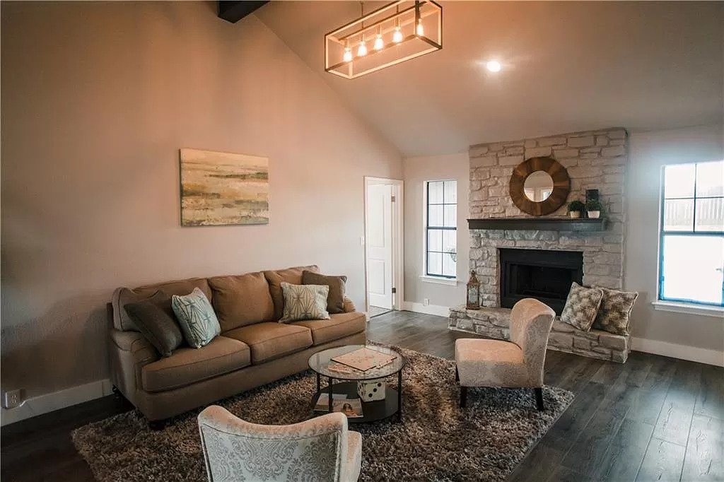 Upgraded living room with vaulted ceiling and accent light fixtures